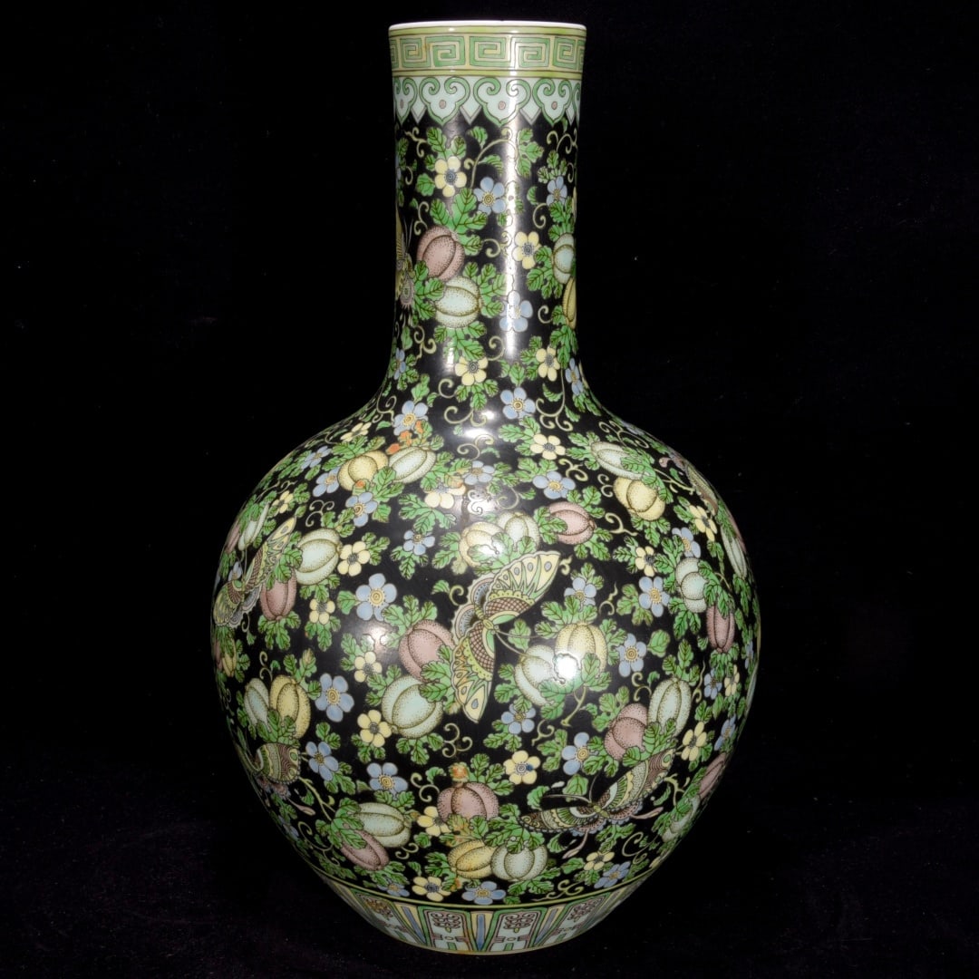 A Exquisite Black Ground Tri-Color Glazed Melon and Butterfly Pattern Vase: A Exquisite Black Ground Tri-Color Glazed Melon and Butterfly Pattern Vase,Qing Dynasty, China,Kangxi Six-character Mark,Size:18.5inx11.8in 黑地三彩瓜蝶纹