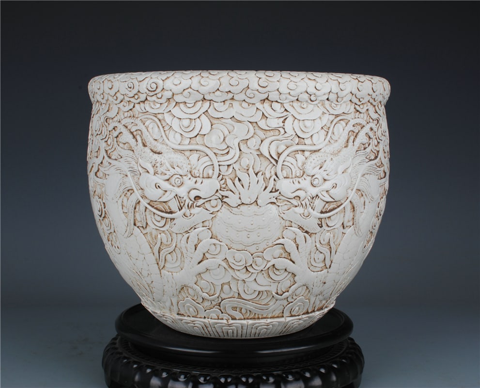 A Exquisite White Glaze Carved Dragon Pattern Vat: A Exquisite White Glaze Carved Dragon Pattern Vat,Qing Dynasty, China,With Mark,Size:8.9inx10.4in 白釉雕刻龙纹缸,中国清代,带