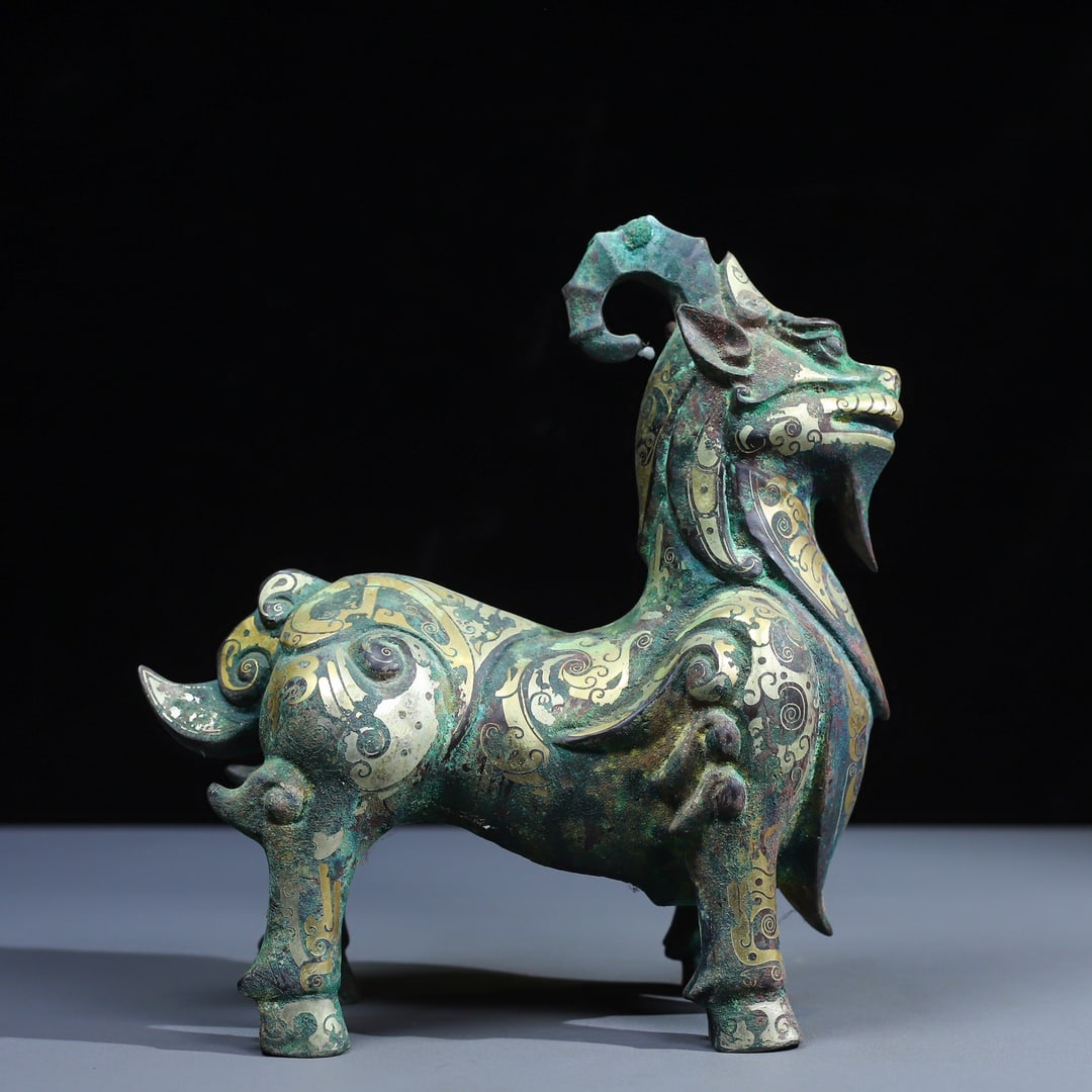 An Archaic Bronze Inlaid Gold and Silver Auspicious Beast Ornament: An Archaic Bronze Inlaid Gold and Silver Auspicious Beast Ornament,Qing Dynasty,China,Size:9.1inx9.1in,Weight:1800g青铜错金银瑞兽摆件,中