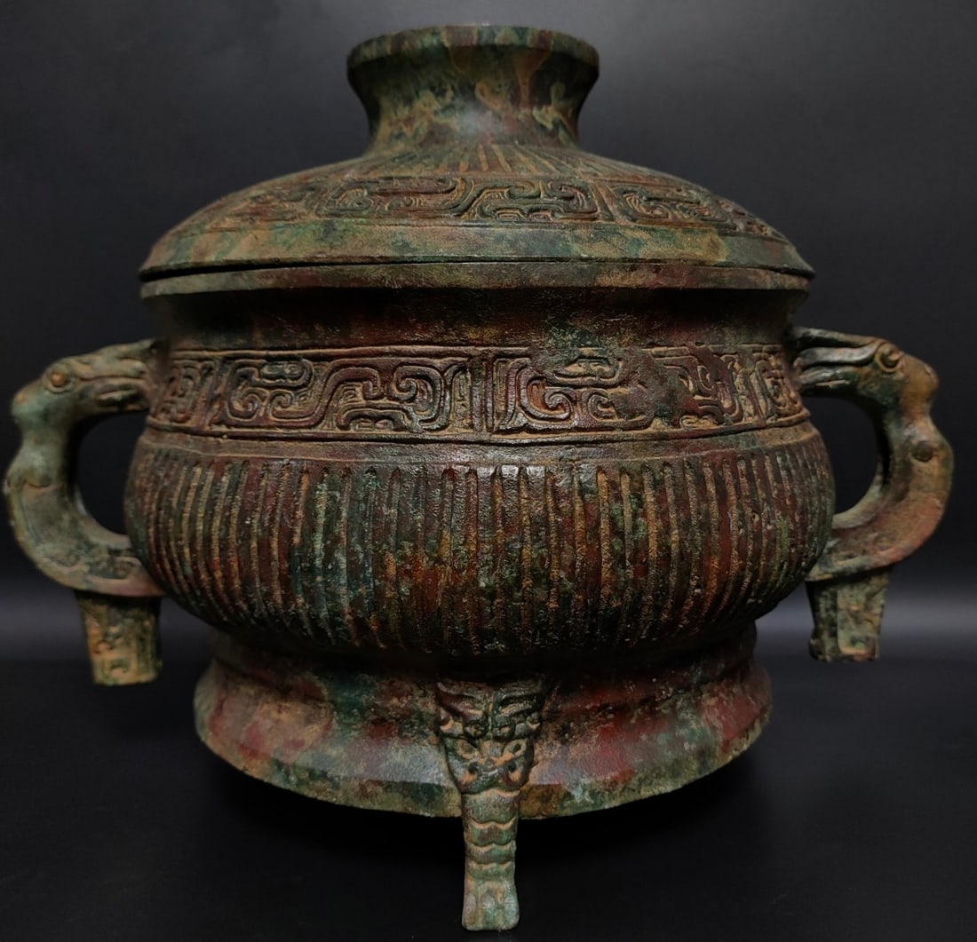 An Archaic Bronze Dragon-Ears Tripod Censer,With Inscription: An Archaic Bronze Dragon-Ears Tripod Censer,With Inscription,the Shang and Zhou Dynasties of China,Size:9.4inx11.8in,Weight:3800g青铜龙耳三足香炉,४