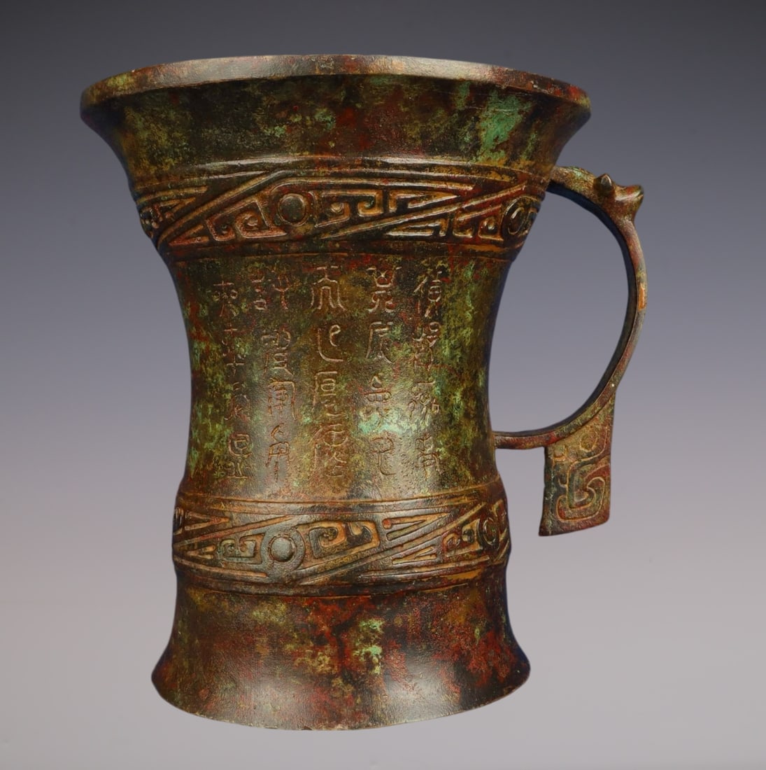 An Archaic Bronze Inscription Cup: An Archaic Bronze Inscription Cup,Han Dynasty,China,Size:7.3inx7.5in,Weight:1900g青铜铭文杯,中国汉代,Size:18.5cmx19cm,Weight:1900g