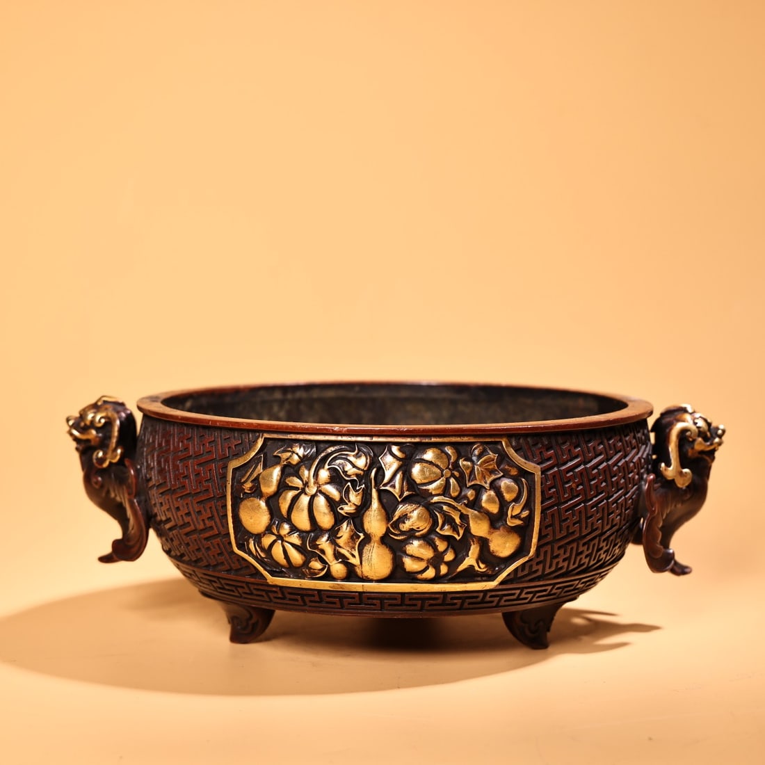 An Exquisite Gilt Bronze Gourd Pattern Beast-Ears Tripod Censer: An Exquisite Gilt Bronze Gourd Pattern Beast-Ears Tripod Censer,Ming Dynasty, China,Xuande Mark,Size:3.3inx9.4in,Weight:3300g铜鎏金葫芦纹兽耳三