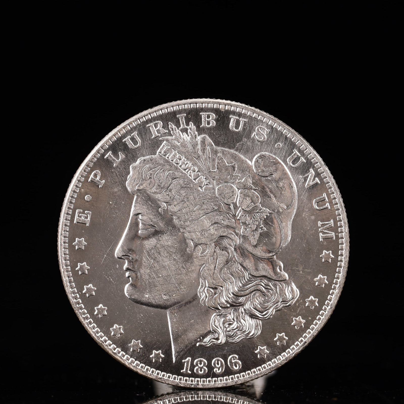 USA Morgan Dollar 1896 Coin: Obv: profile bust with date below and E PLURIBUS UNUM legend and stars around. Rev: eagle with In God we trust above within wreath with UNITED STATES OF AMERICA ONE DOLLAR legend. IN GOD WE TRUST / LI