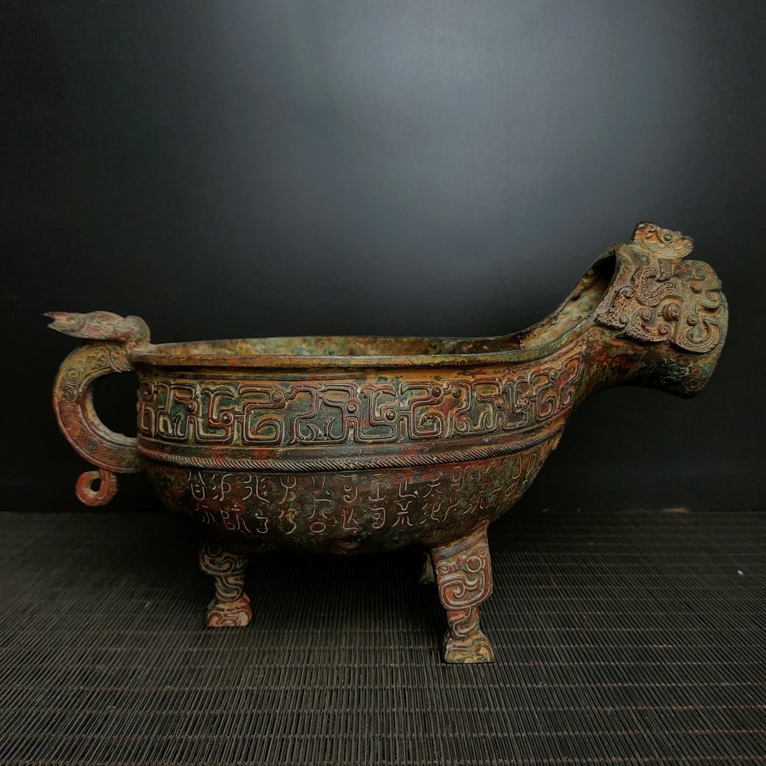 An Archaic Bronze Beast-Face Pattern Tripod Goblet,With Inscription: An Archaic Bronze Beast-Face Pattern Tripod Goblet,With Inscription,the Shang and Zhou Dynasties of China,Size:6.7inx10.6in,Weight:1200g青铜兽面纹三足爵