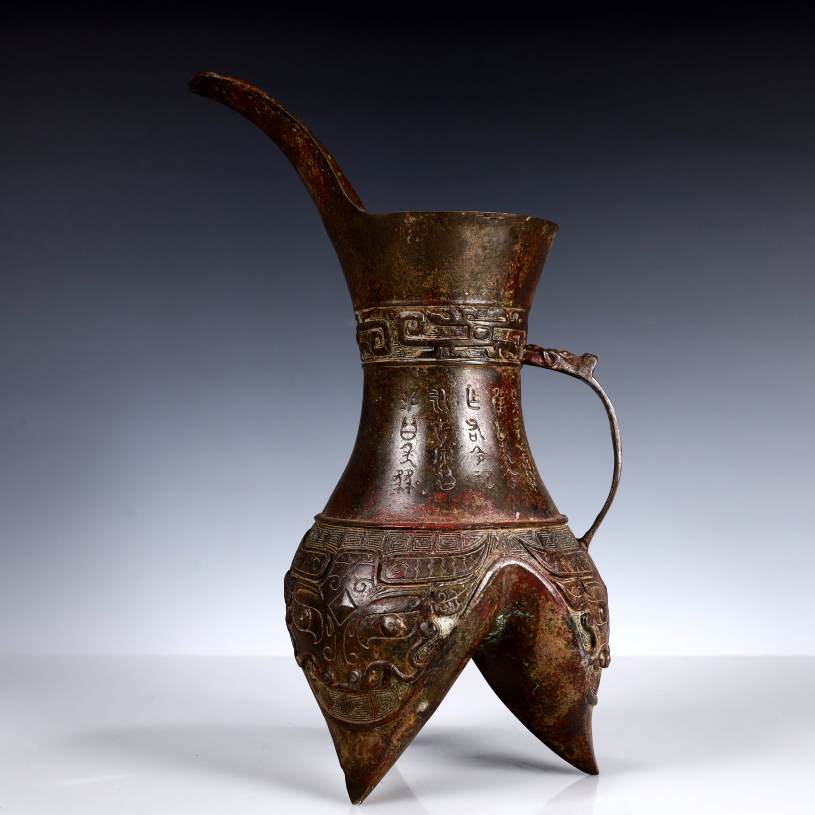 A Rare Bronze Beast-Face Pattern Flagon: A Rare Bronze Beast-Face Pattern Flagon,W.Zhou,China,Size:7.1inx7.1inx13in,Weight:1850g 青铜兽面纹酒壶,中国西周时期