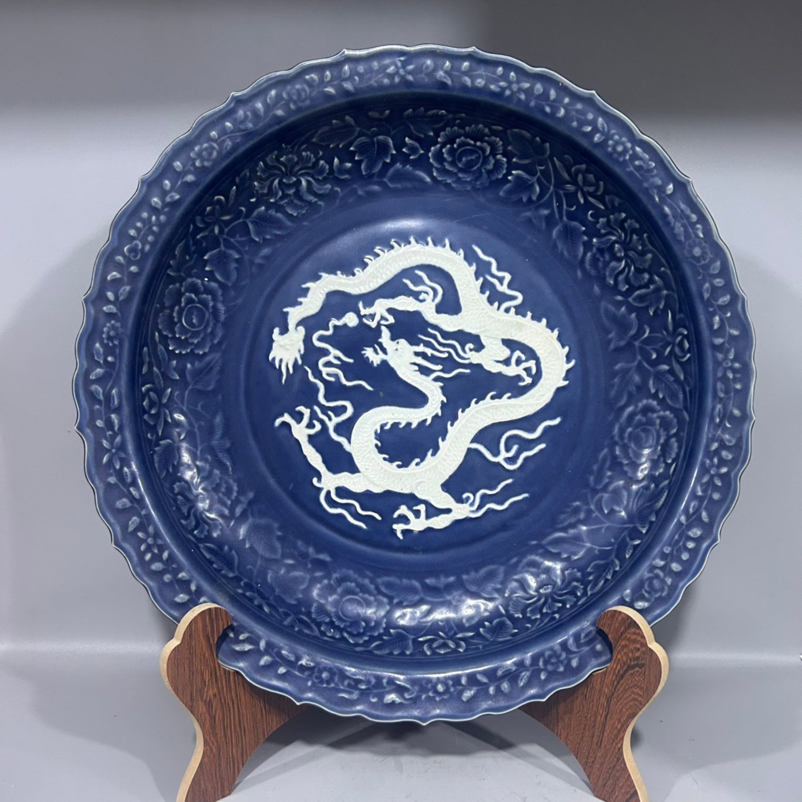 A Huge Ji Blue Glazed Peony and Dragon Pattern Plate: A Huge Ji Blue Glazed Peony and Dragon Pattern Plate,Qing Dynasty,China,Size:17.7inx2.8in 霁蓝釉牡丹龙纹盘,中国清代
