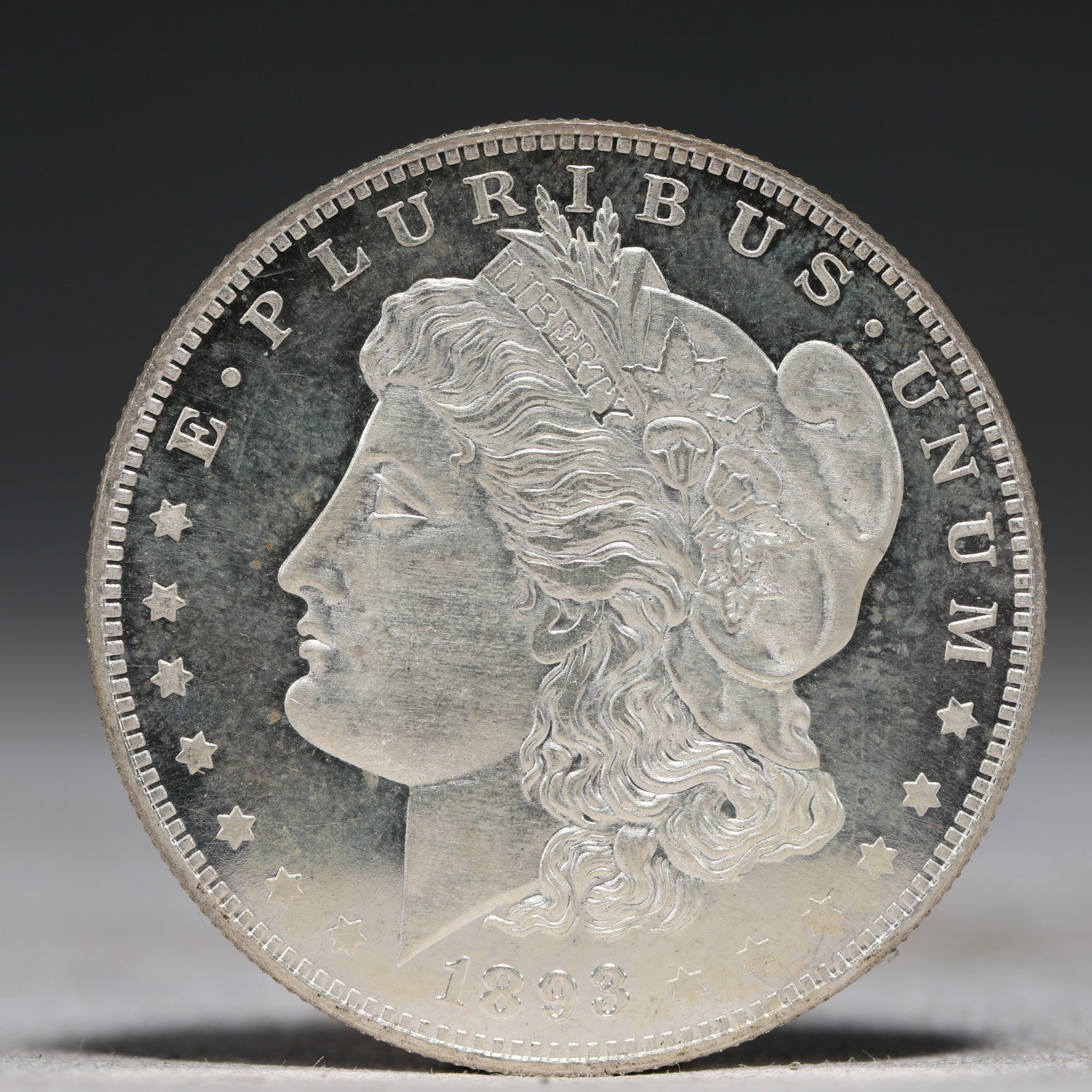 USA Morgan Dollar 1893 Coin: Obv: profile bust with date below and E PLURIBUS UNUM legend and stars around. Rev: eagle with In God we trust above within wreath with UNITED STATES OF AMERICA ONE DOLLAR legend. IN GOD WE TRUST / LI