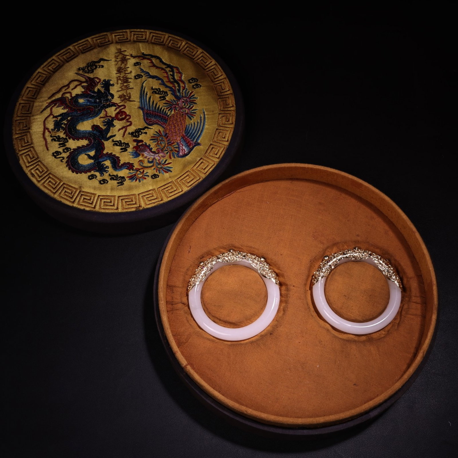 A Pair of Exquisite Filigree and Gilding Inlaid White Jade Bracelets: A Pair of Exquisite Filigree and Gilding Inlaid White Jade Bracelets,Qing Dynasty,China,Size:2.4in,Weight:58g 一对花丝鎏金嵌白玉手镯,&