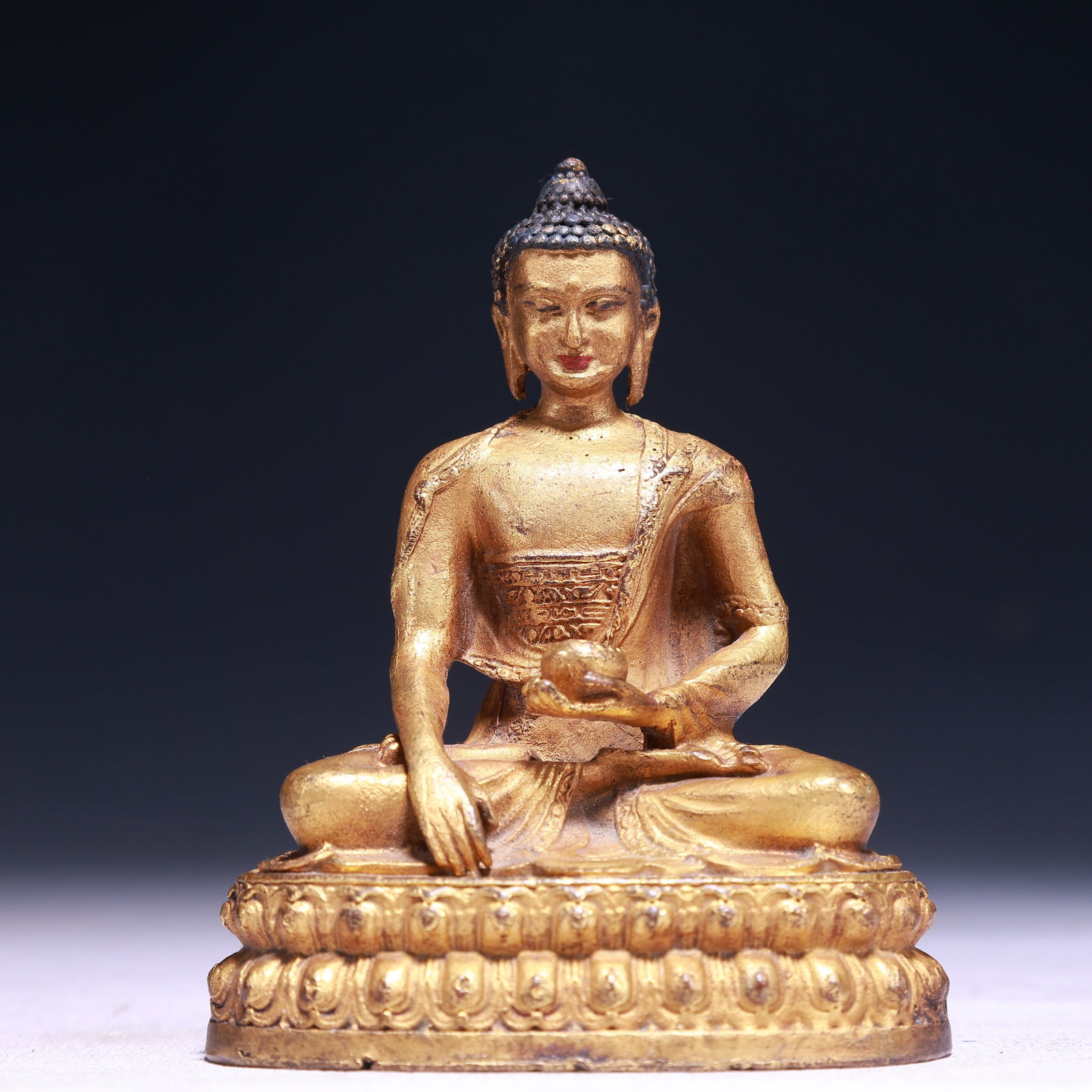 A Solemn Gilt Bronze Statue of Sakyamuni: A Solemn Gilt Bronze Statue of Sakyamuni,Qing Dynasty,China,Size:3inx2inx3.5in,Weight:300g 铜鎏金释迦摩尼像,中国清代