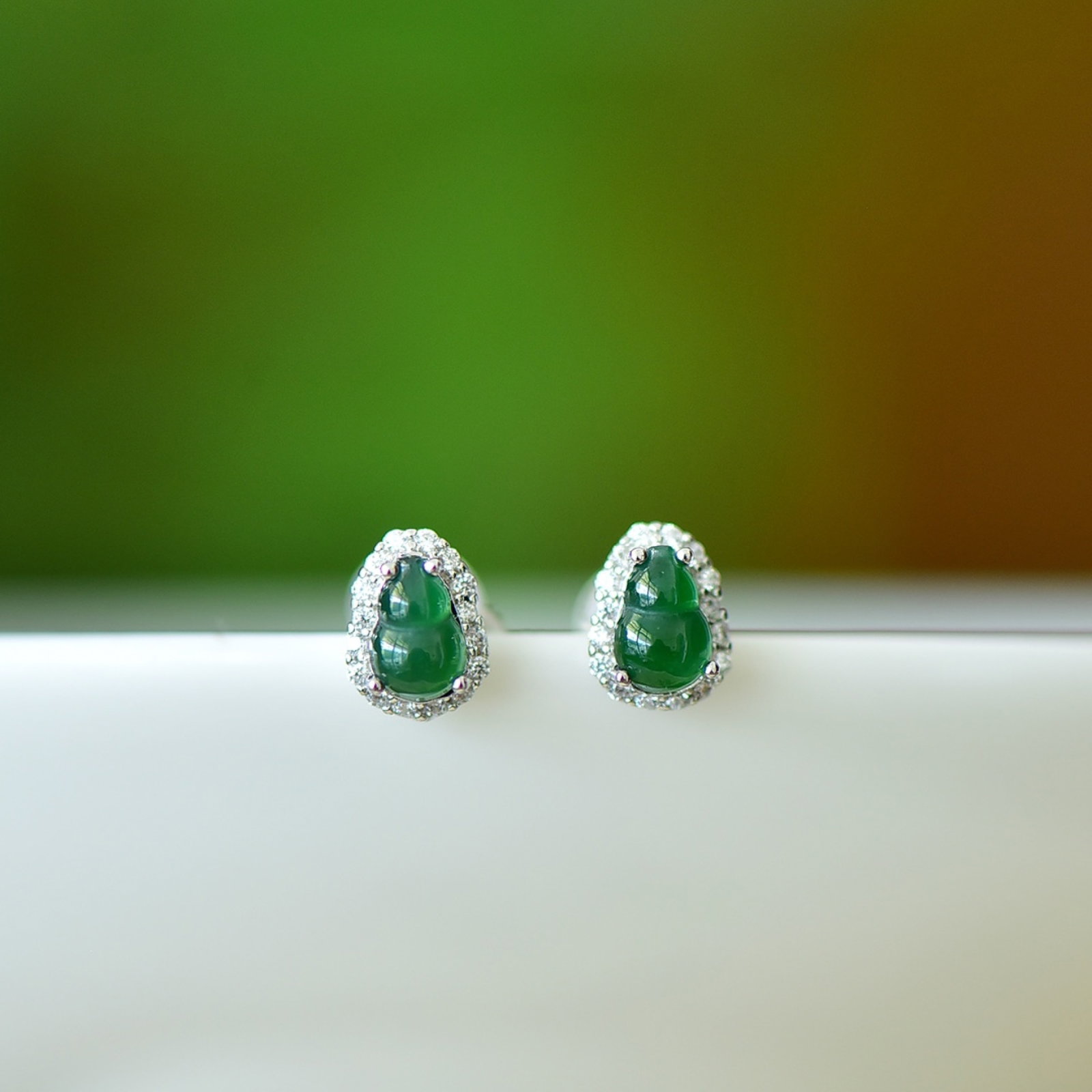 A Pair of Exquisite Sterling Silver Inlaid Jadeite Gourd Earrings,Inlaid Diamond: A Pair of Exquisite Sterling Silver Inlaid Jadeite Gourd Earrings,Inlaid Diamond,Size:4mmx6mm 一对纯银镶翡翠葫芦耳钉,嵌钻&