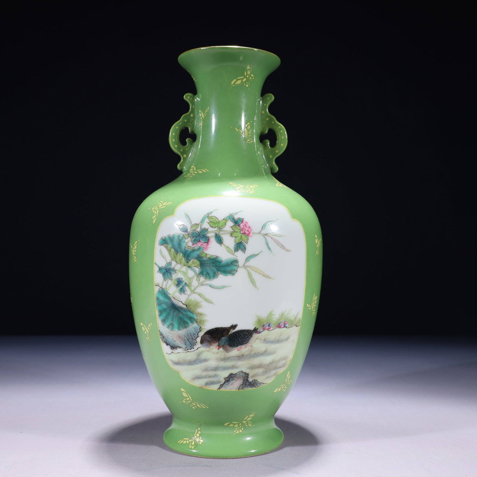 An Exquisite Green Ground Famille-Rose Painted Gold Flower and Bird Pattern Double-Ears Vase: An Exquisite Green Ground Famille-Rose Painted Gold Flower and Bird Pattern Double-Ears Vase,Qing Dynasty,China,Qianlong Six-character Mark,Size:5.9inx13in,Weight:1650g 绿地粉彩
