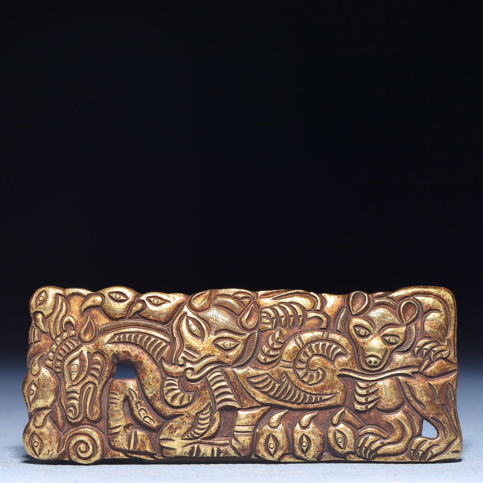An Exquisite Gilt Silver Beast Pattern Ornament: An Exquisite Gilt Silver Beast Pattern Ornament,Qing Dynasty,China,Size:3.7inx1.4in,Weight:47.5g 银鎏金兽纹摆件,中国清代