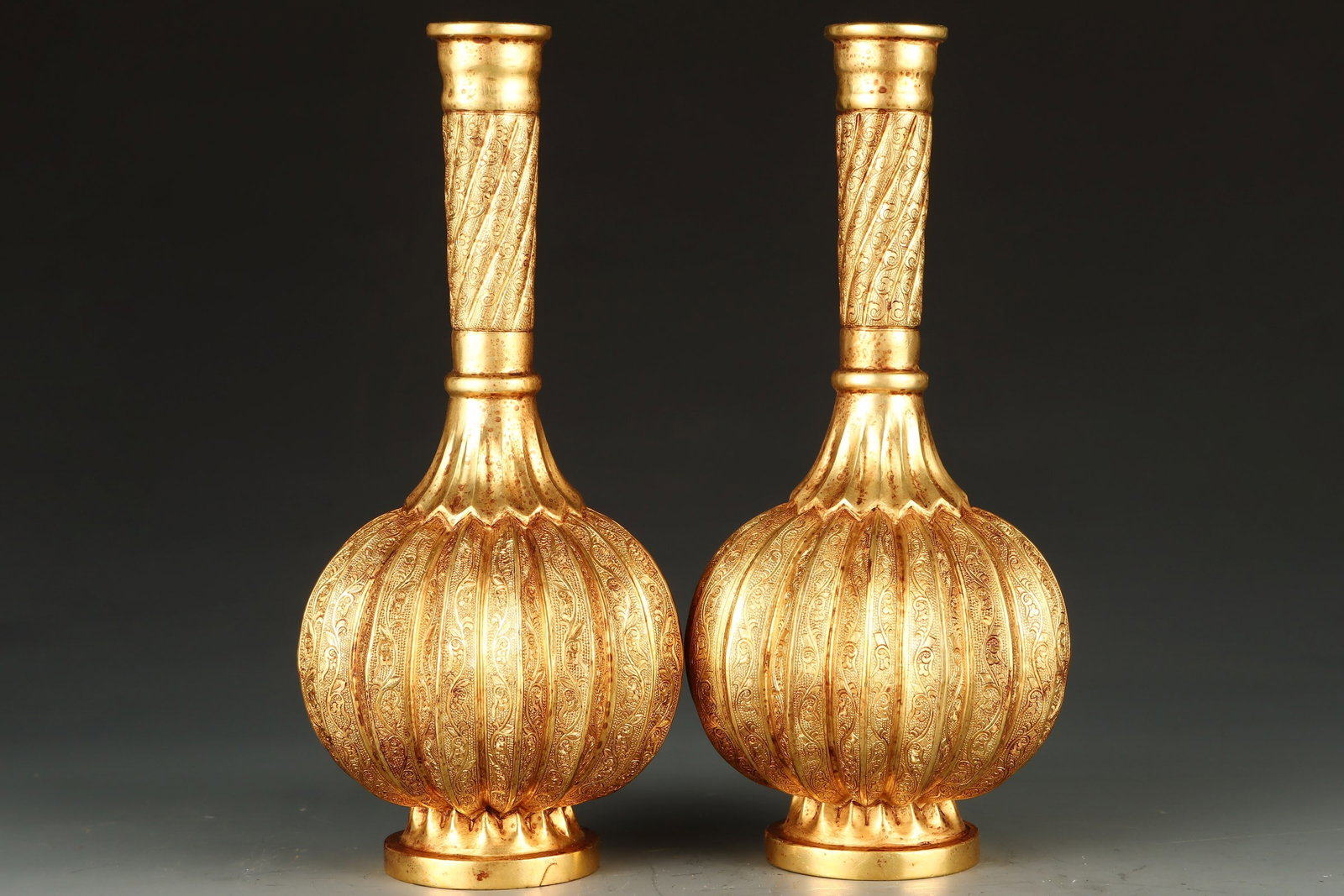 A pair of Exquisite Gilt Bronze Scroll Grass Pattern Vase: A pair of Exquisite Gilt Bronze Scroll Grass Pattern Vase,Tang Dynasty,China,Zhenguan Four-character Mark,Size: 3.5inx7.9in,Weight: 953g（Pair） 一对铜鎏金