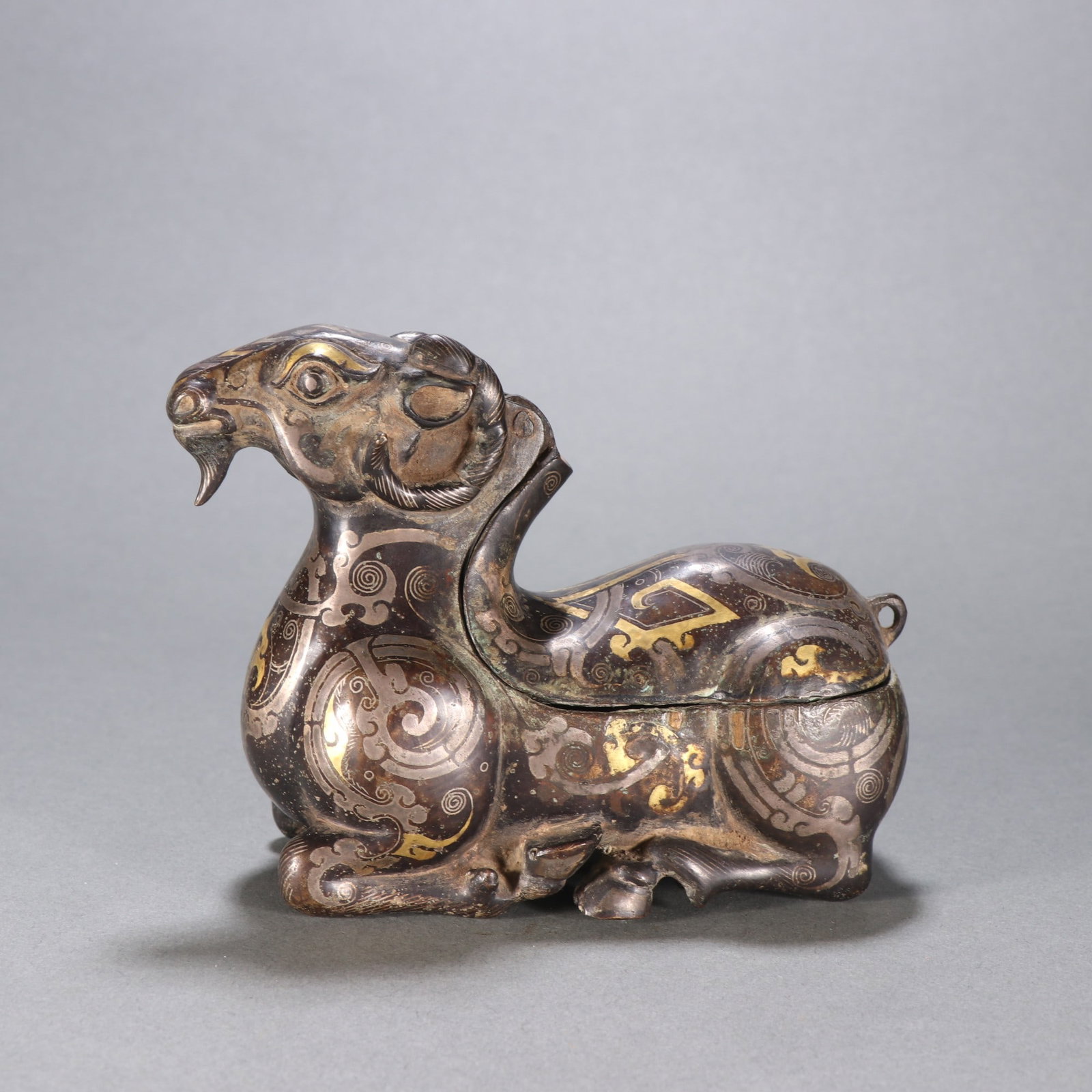 A Exquisite Gold and Silver-Inlaid Bronze Sheep Candlestick: A Exquisite Gold and Silver-Inlaid Bronze Sheep Candlestick,Han Dynasty, China,Size:3.9inx5in,Weight:576.9g 铜错金银羊烛台,中国汉代