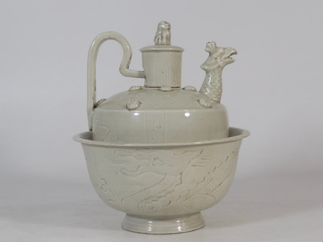 An Exquisite Ding yao Dragon Pattern Phoenix-head Flagon: An Exquisite Ding yao Dragon Pattern Phoenix-head Flagon,Qing Dynasty,China, Size:9.3inx8.1in定窑龙纹凤首酒壶,中国清代, Size:23.