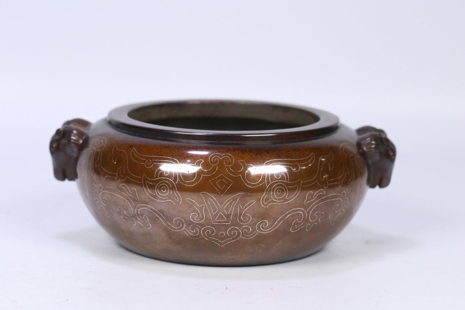 An Exquisite Bronze Inlaid Silver Beast-Face Pattern Sheep-Ears Censer: An Exquisite Bronze Inlaid Silver Beast-Face Pattern Sheep-Ears Censer,Qing Dynasty, China,Shisou Mark Size:7.3inx6.2inx2.8in,Weight:3044g铜错银兽面纹羊೑