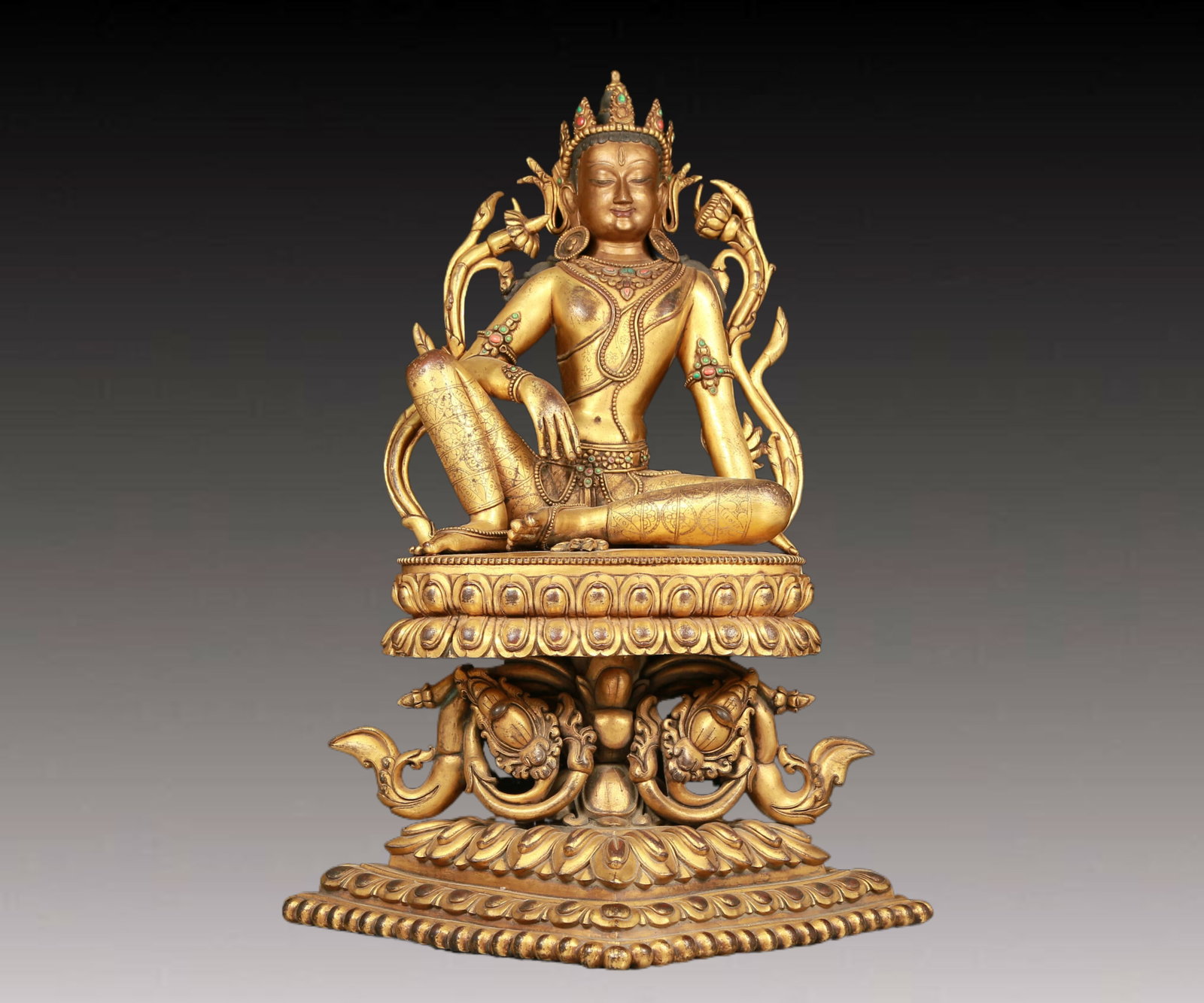 A solemn gilt bronze statue of Tara inlaid gems: A solemn gilt bronze statue of Tara inlaid gems,seven-character Qianlong mark,Qing Dynasty,China. Tara has an elegant posture,with a peaceful and compassionate expression. Her face is soft and A