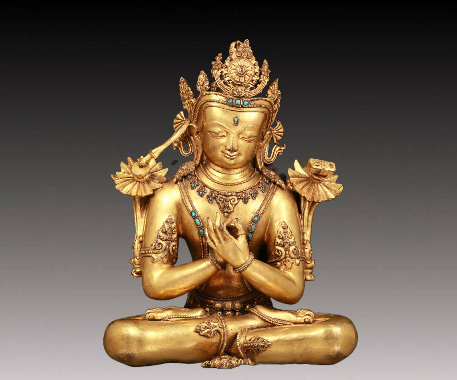 A solemn gilt bronze statue of Manjusri Bodhisattva inlaid with turquoise: A solemn gilt bronze statue of Manjushri Bodhisattva inlaid with turquoise. During the Ming Dynasty of China,Manjushri Bodhisattva wore a gorgeous crown. The crown was dotted with gems,making it look 