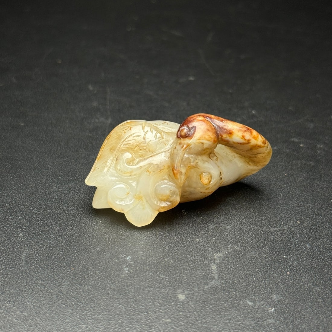 An Exquisite White Jade Auspicious Animal Ornament: An Exquisite White Jade Auspicious Animal Ornament,Han Dynasty,China,Size:1.8inx1.1inx0.9in,Weight:29g,白玉瑞兽摆件,中国汉代