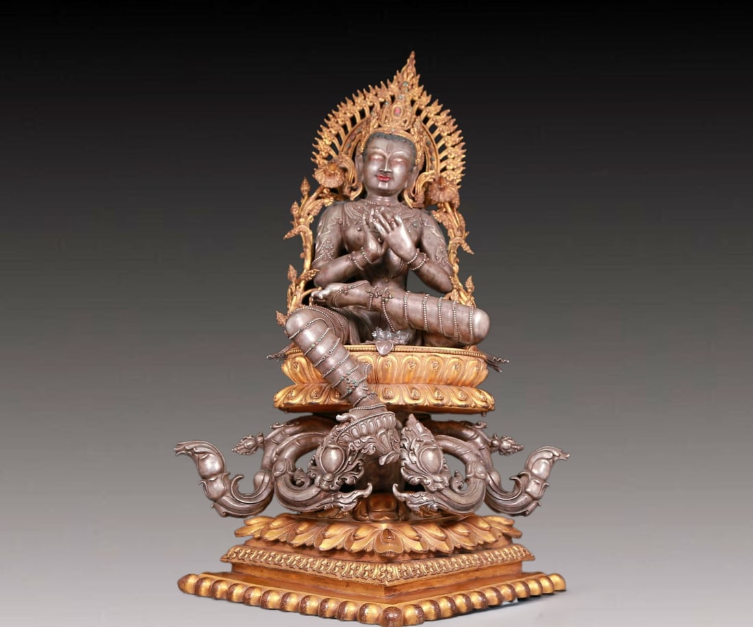 A solemn gilt bronze and silver inlaid sapphire green Tara statue (1 of 17)