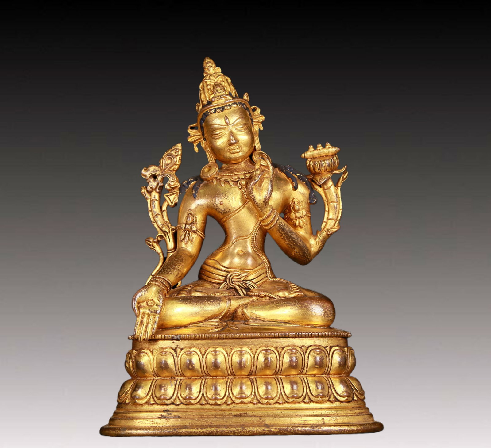 An exquisite gilt bronze statue of White Tara: An exquisite gilt-bronze white Tara statue,Ming Dynasty,China. Tara has an elegant posture with a peaceful and compassionate expression. Her face is soft and solemn,and her eyes are warm. She seems to