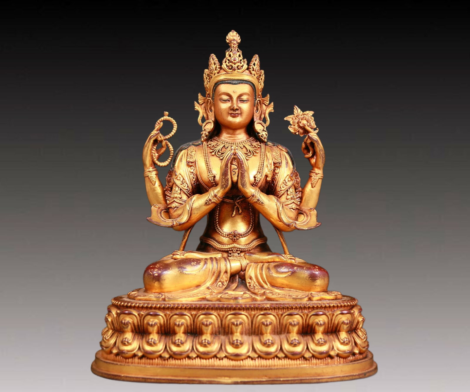 A solemn gilt bronze four-armed Guanyin statue: A solemn gilt bronze four-armed Guanyin statue,Qianlong seven-character mark,Qing Dynasty,China. The four-armed Guanyin is regarded as a symbol of compassion and wisdom in Buddhism and is a highly rev