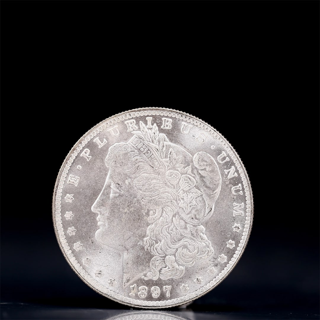 USA Morgan Dollar 1897 Coin: Obv: profile bust with date below and E PLURIBUS UNUM legend and stars around. Rev: eagle with In God we trust above within wreath with UNITED STATES OF AMERICA ONE DOLLAR legend. IN GOD WE TRUST / LI
