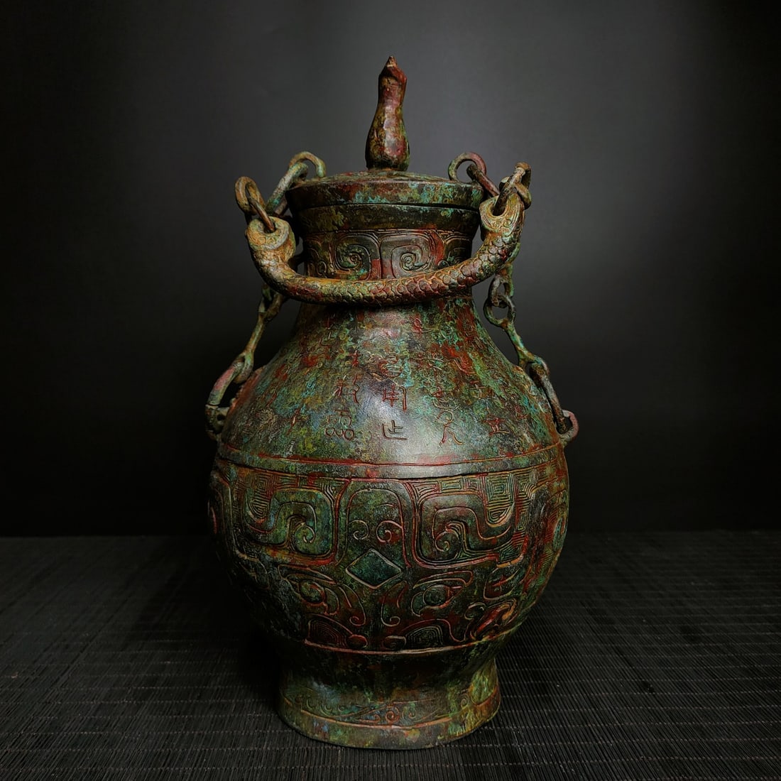 An Archaic Bronze Beast-Face Pattern Double-Ears Bottle,With Inscription: An Archaic Bronze Beast-Face Pattern Double-Ears Bottle,With Inscription,the Warring States period in China,Size:13.8inx7.5in,Weight:2500g青铜兽面纹双耳௢