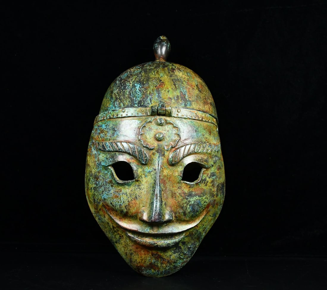 An Archaic Bronze Figure-Face Pattern Helmet: An Archaic Bronze Figure-Face Pattern Helmet ,the Warring States period in China,Size:13inx7.1in,Weight:2000g青铜人面纹头盔,中国战国&#