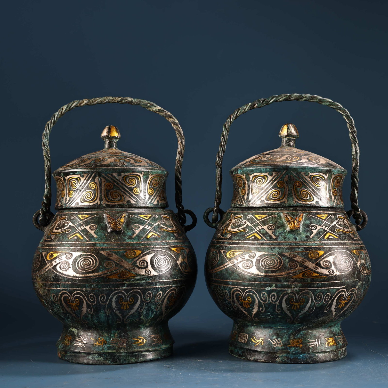 A Pair of Exquisite Bronze Inlaid Gold and Silver Double-Ears Cover Jars,With Inscription: A Pair of Exquisite Bronze Inlaid Gold and Silver Double-Ears Cover Jars,With Inscription,Qing Dynasty, China,Size:9.8inx6.3in,Total Weight:4800g一对青铜错金银