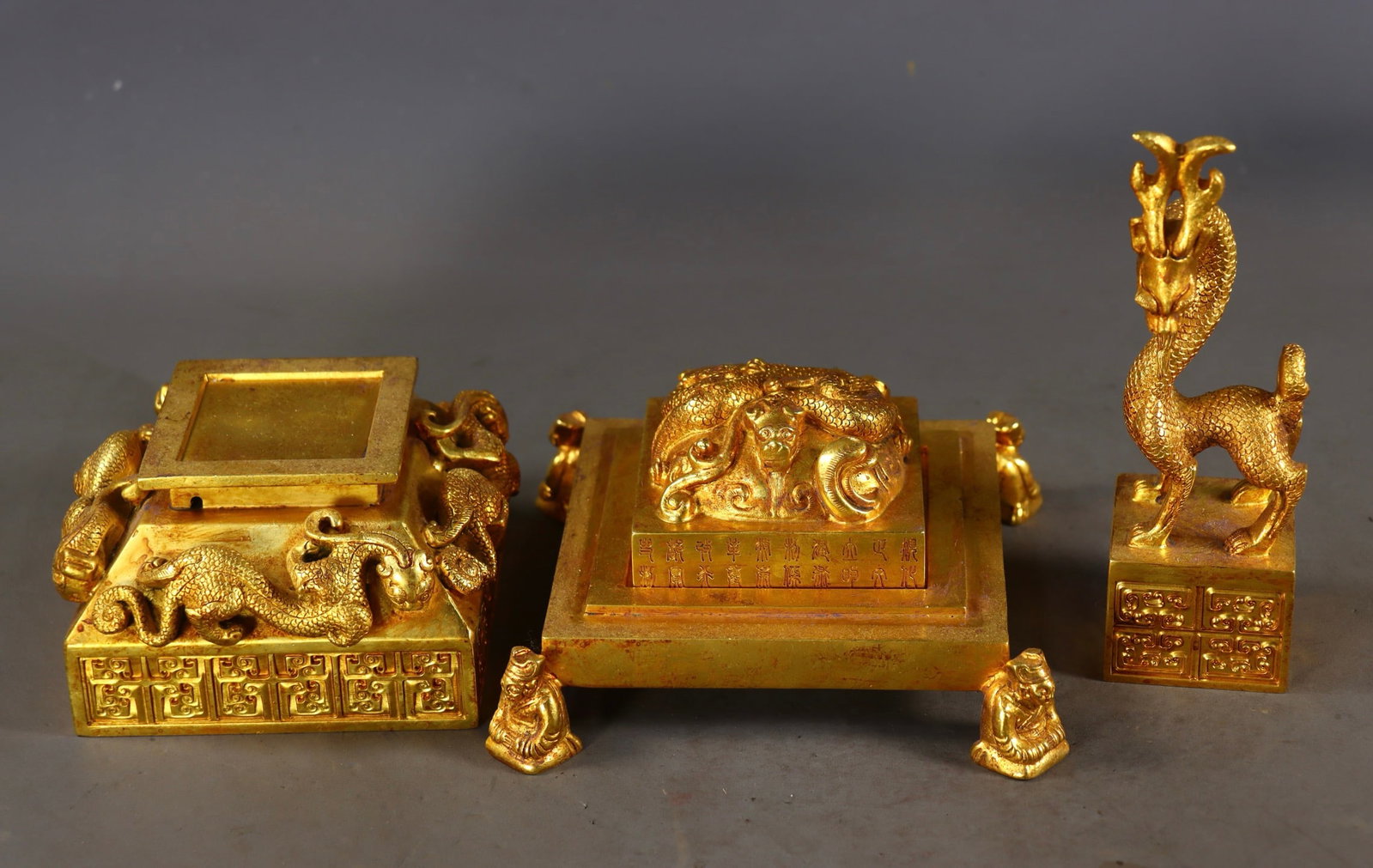 A Set of Fine Gilt Bronze Dragon Pattern Seals,With Poem: A Set of Fine Gilt Bronze Dragon Pattern Seals,With Poem,Qing Dynasty,China,Size:(Total)10.4inx6.1in,(Deer)6.7inx2in,(Dragon)2inx3.1in,Total Weight:4883g一套铜鎏金龙