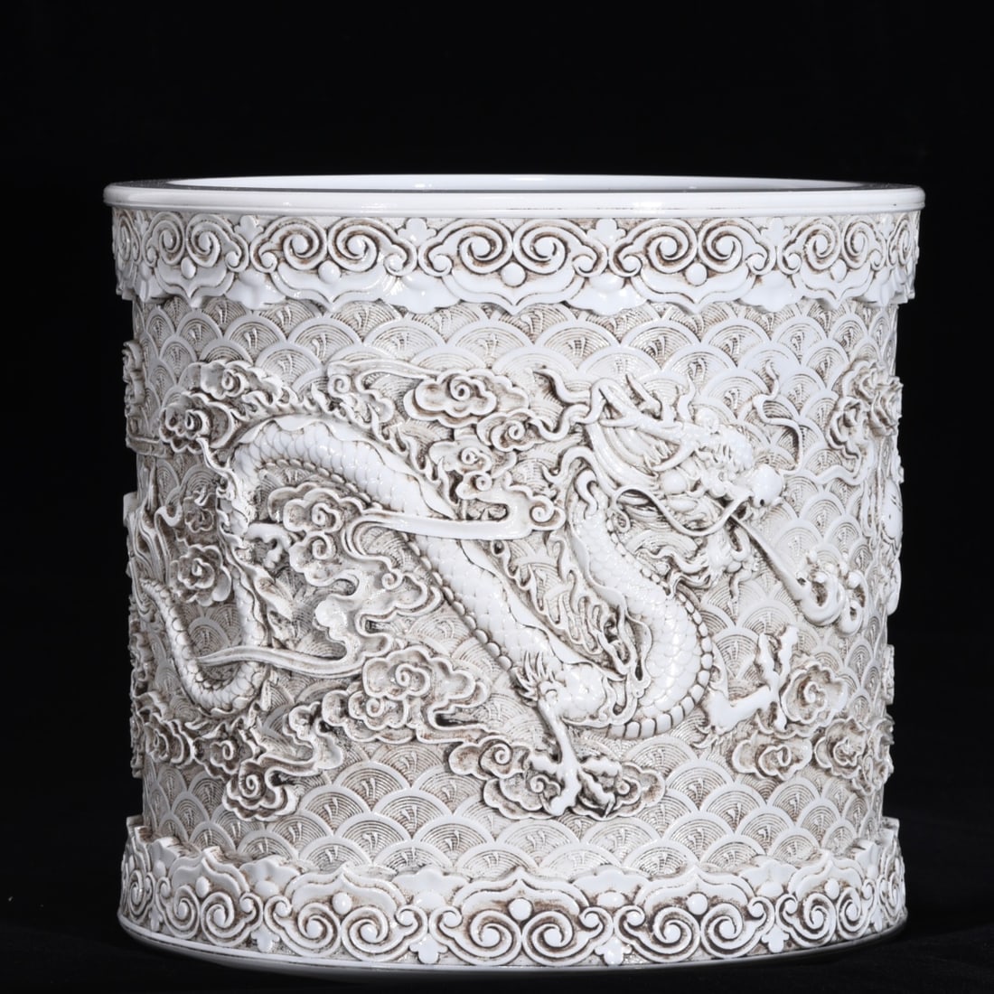 An Exquisite White Glaze Dragon Pattern Brush Pot: An Exquisite White Glaze Dragon Pattern Brush Pot Qing Dynasty, China Size:7.9inx8.7in双龙戏珠笔筒 中国清代 Size:20cmx22cm