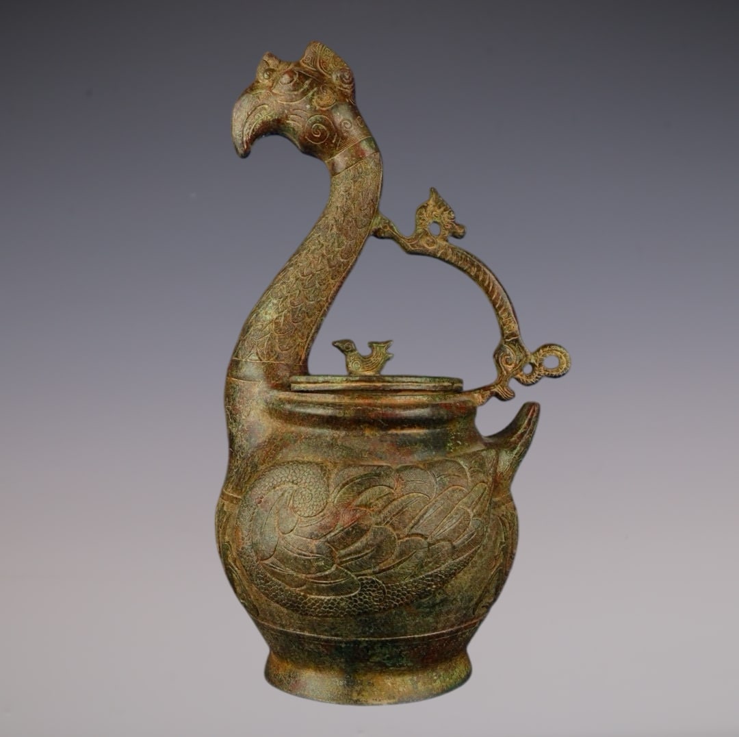 An Archaic Bronze Dragon Pattern Phoenix-Shaped Pot: An Archaic Bronze Dragon Pattern Phoenix-Shaped Pot,Han Dynasty,China,Size:9.4inx7.5inx16.5in,Weight:3850g青铜龙纹凤形壶,中国汉代,Size