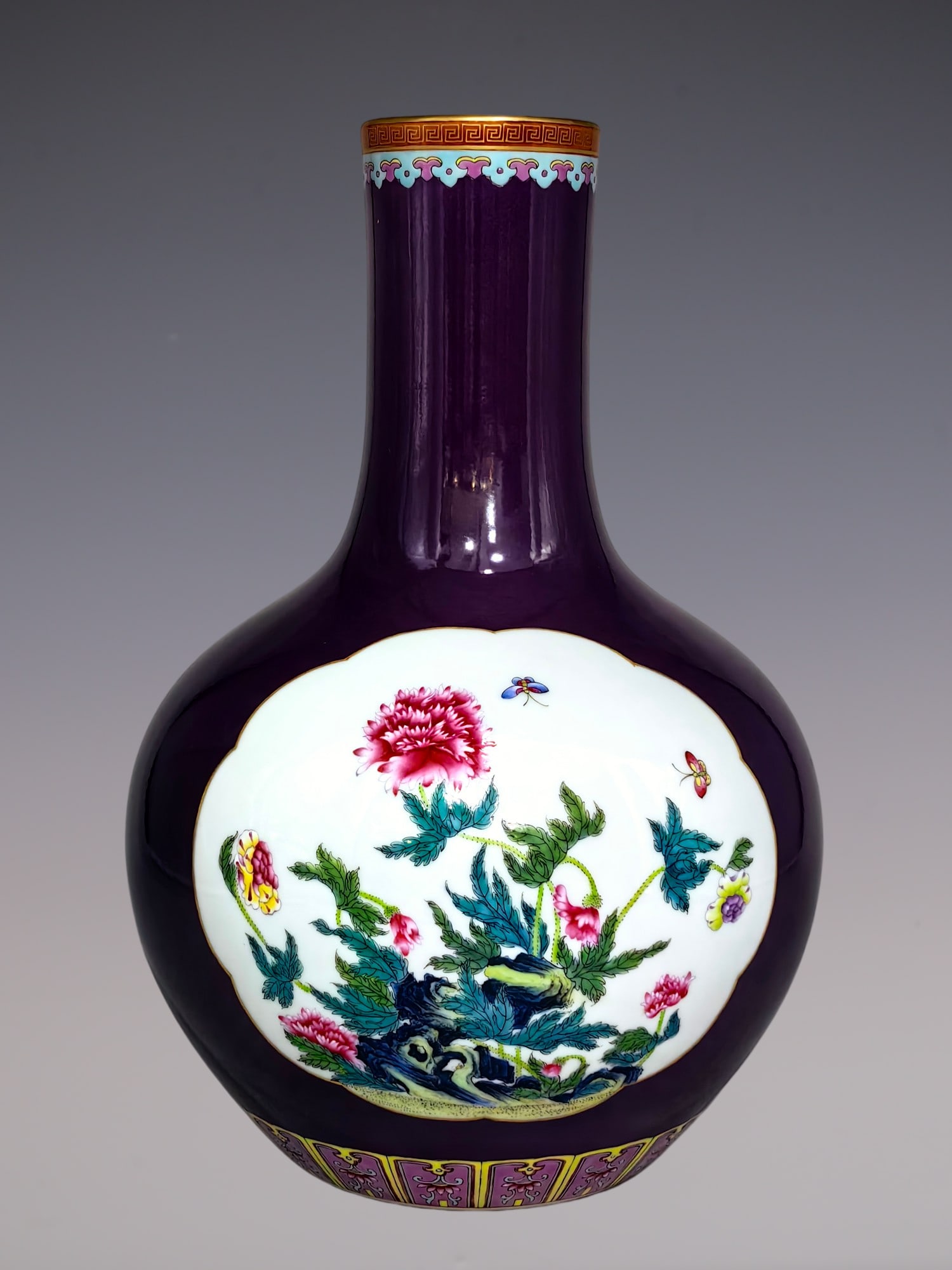 An Exquisite Famille-Rose Flower and Butterfly Pattern Vase: An Exquisite Famille-Rose Flower and Butterfly Pattern Vase Qing Dynasty, China Yongzheng Six-character Mark Size:12.8inx9.1in粉彩紫底开窗花卉纹&#