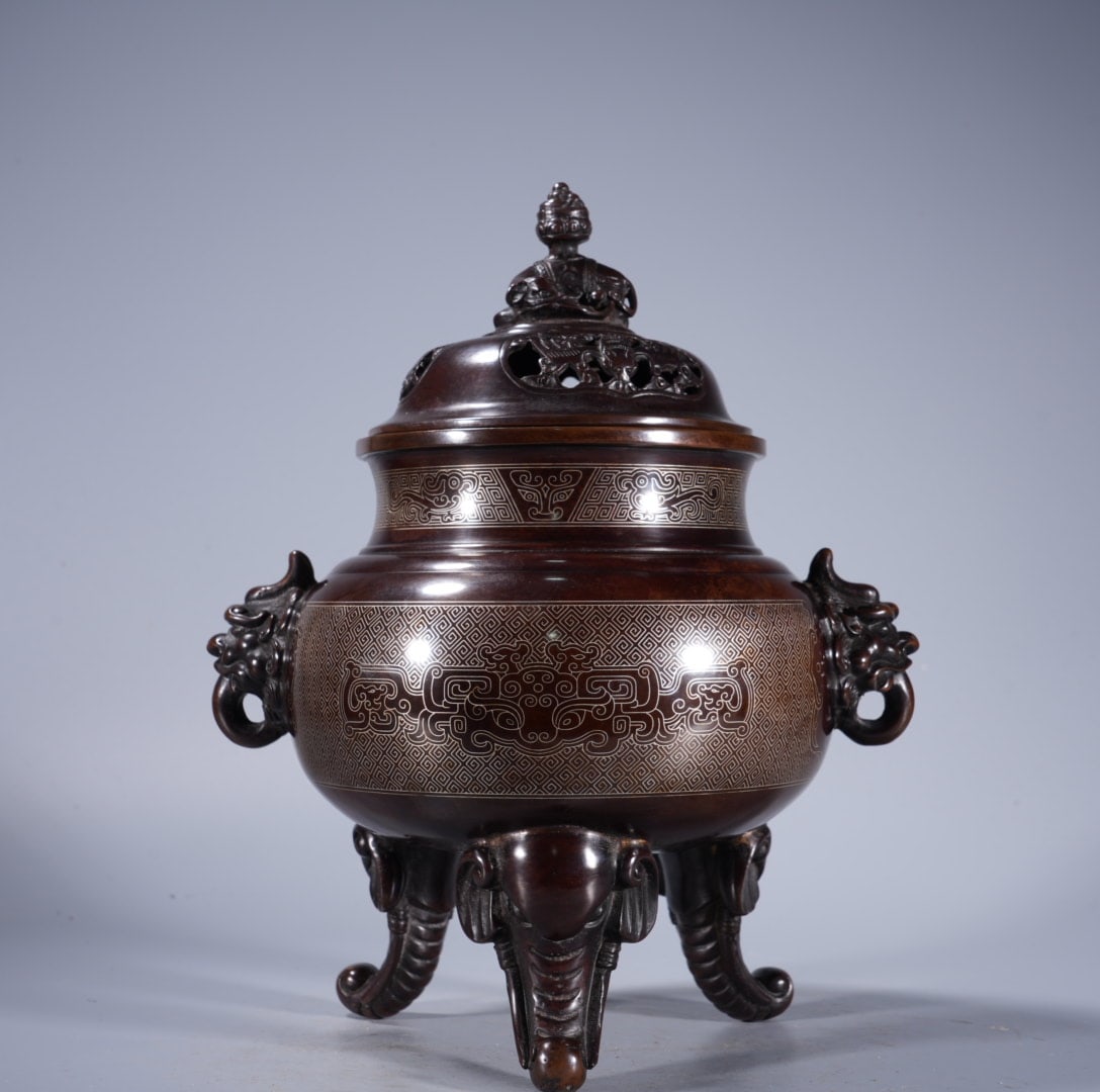 An Exquisite Silver-Inlaid Bronze Double-Ears and Tripod Censer: An Exquisite Silver-Inlaid Bronze Double-Ears and Tripod Censer,Ming Dynasty, China,With Mark,Size:9.1inx4.4in ,Weight:3760g 紫铜错银双耳三足炉,&#