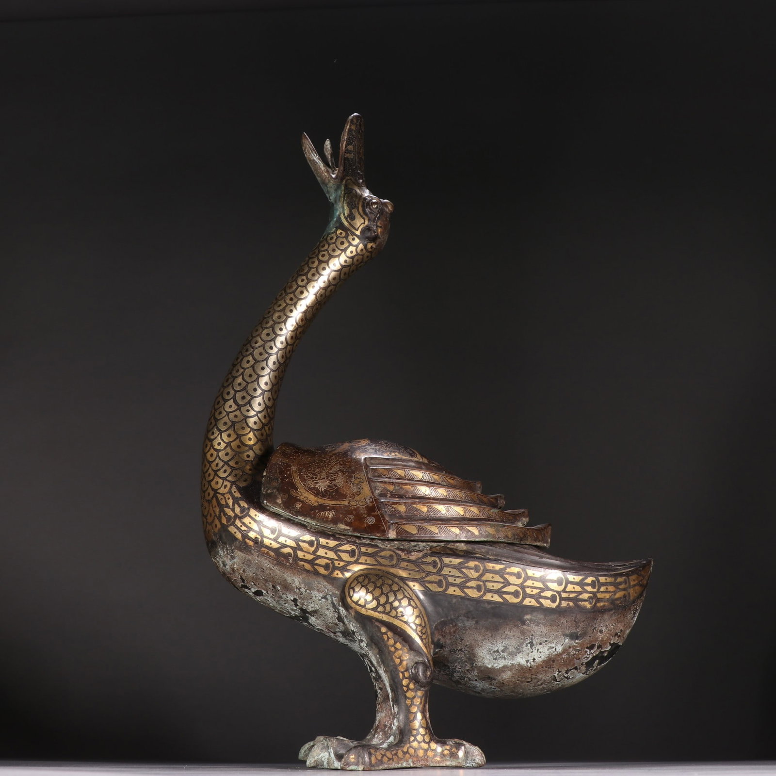 An Exquisite Gold and Silver-Inlaid Bronze Duck Vase: An Exquisite Gold and Silver-Inlaid Bronze Duck Vase,Qing Dynasty, China,Size:14.6inx9.4in,Weight:2227.8g 铜错金银鸭瓶,中国清代