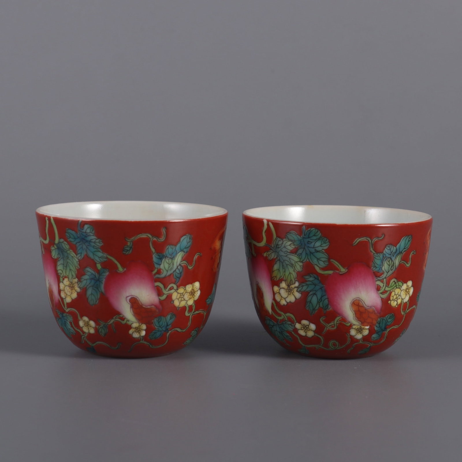 A pair of Exquisite Coral Red Ground Famille-Rose Pomegranate Pattern Cup: A pair of Exquisite Coral Red Ground Famille-Rose Pomegranate Pattern Cup,Qing Dynasty, China,Yongzheng Six-character Mark,Size:1.9inx2.4in