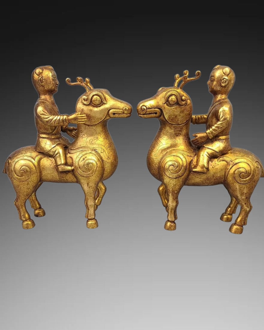 A pair of Exquisite Gilt Bronze Figure Riding Deer Ornaments: A pair of Exquisite Gilt Bronze Figure Riding Deer Ornaments,Qing Dynasty, China,Size:9.4in,Weight:5862.6g