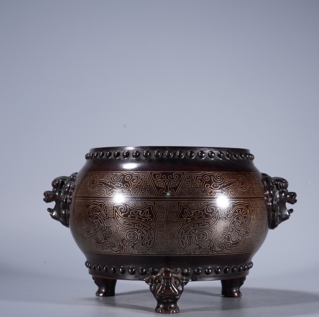 An Exquisite Silver-Inlaid Bronze Lion-Ears Censer: An Exquisite Silver-Inlaid Bronze Lion-Ears Censer,Ming Dynasty, China,With Mark,Size:4.3inx4.9in ,Weight:2675g 紫铜错银狮耳炉,中国明代