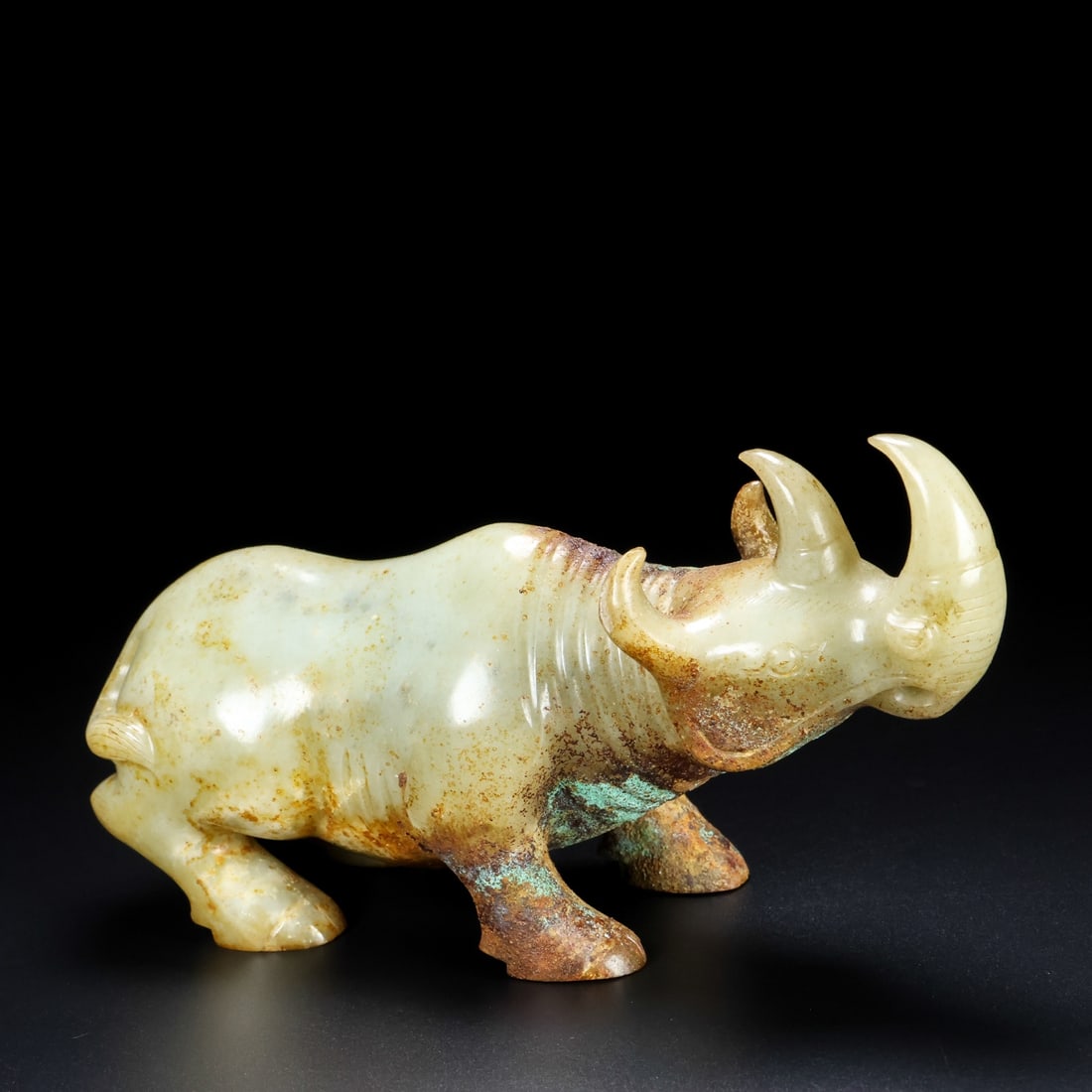 An Exquisite Hotan Jade Rhinoceros Ornament: An Exquisite Hotan Jade Rhinoceros Ornament,Han Dynasty, China,Size:5.9inx1.9inx3.1in,Weight:626g 和田玉犀牛摆件,中国汉代