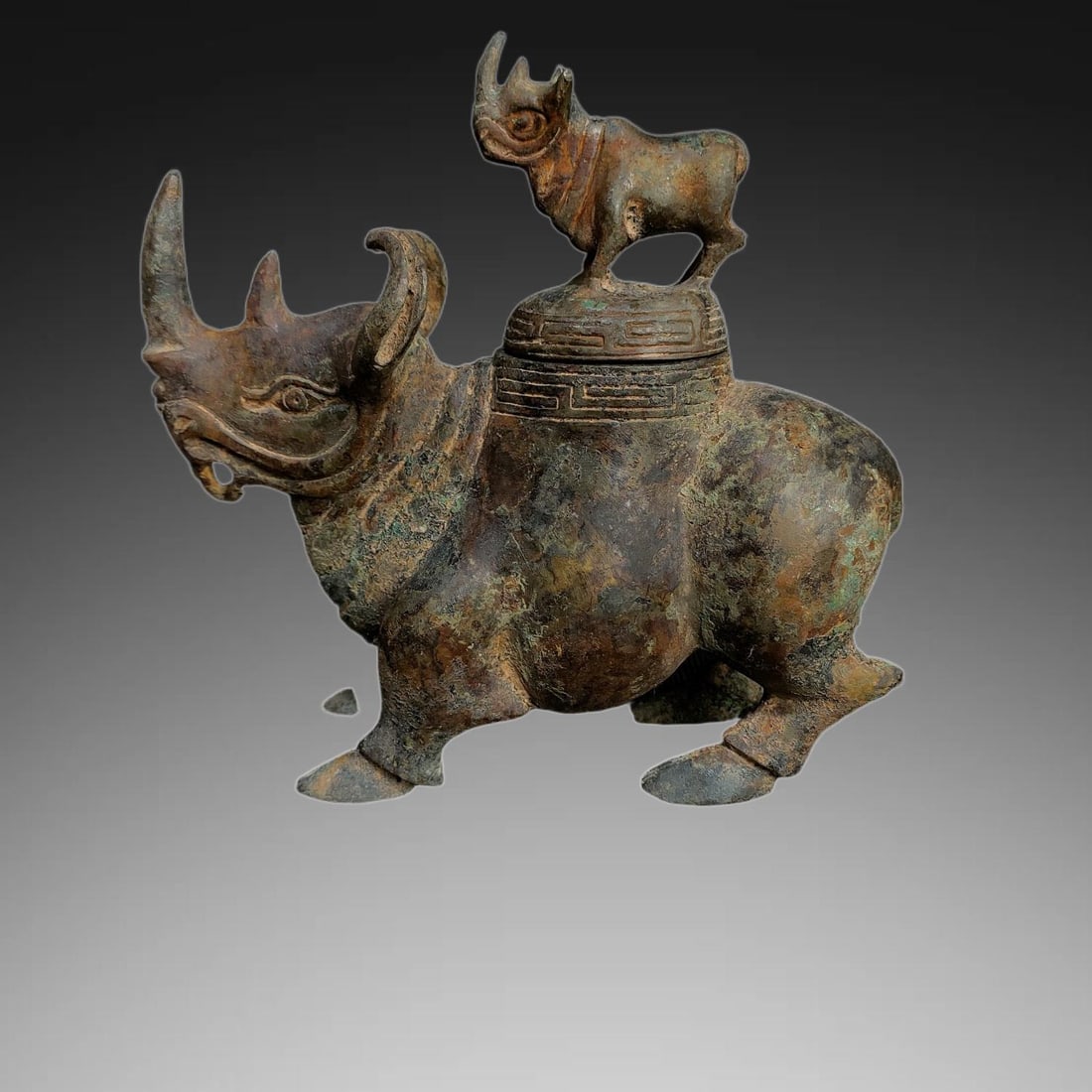 An Exquisite Bronze Rhinoceros Ornament: An Exquisite Bronze Rhinoceros Ornament,Ancient Time, China,Size:7.1inx7.5in ,Weight:1400g 青铜犀牛摆件,远古时期