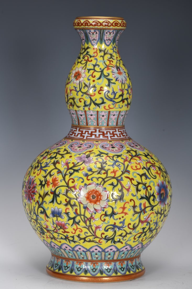 An Exquisite Enamel Yellow Ground Lotus Pattern Gourd Vase: An Exquisite Enamel Yellow Ground Lotus Pattern Gourd Vase,Qing Dynasty, China,Qianlong Six-character Mark,Size:15inx2.7inx8.7inx5.8in 珐琅彩黄地缠枝莲&
