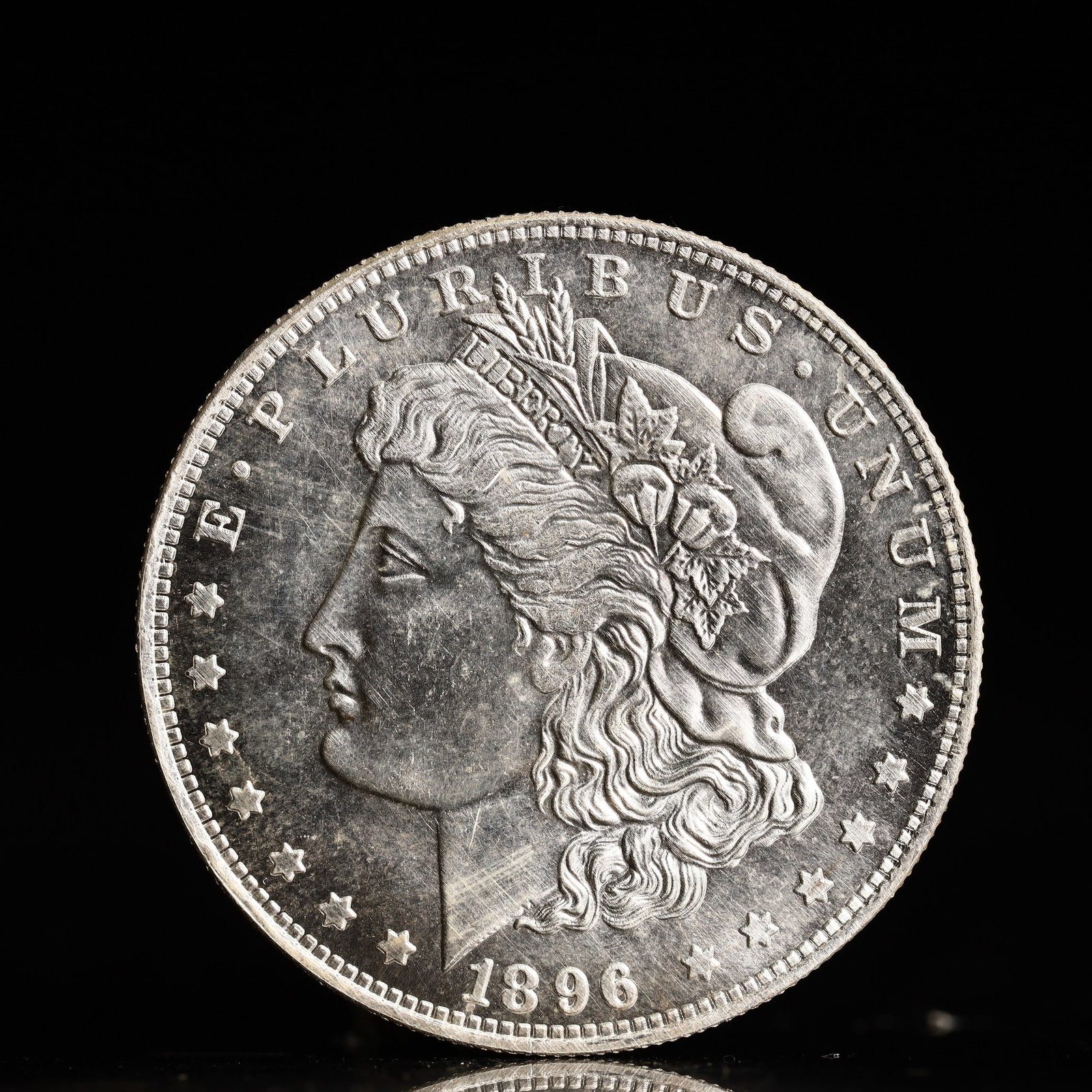USA Morgan Dollar 1896 Coin: Obv: profile bust with date below and E PLURIBUS UNUM legend and stars around. Rev: eagle with In God we trust above within wreath with UNITED STATES OF AMERICA ONE DOLLAR legend. IN GOD WE TRUST / LI