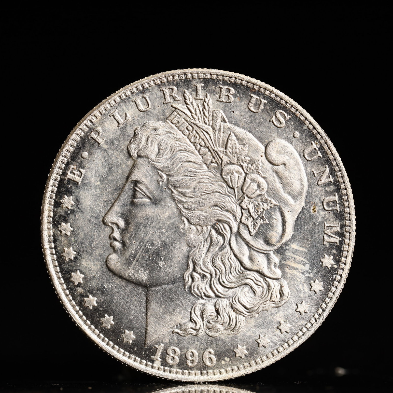 USA Morgan Dollar 1896 Coin: Obv: profile bust with date below and E PLURIBUS UNUM legend and stars around. Rev: eagle with In God we trust above within wreath with UNITED STATES OF AMERICA ONE DOLLAR legend. IN GOD WE TRUST / LI