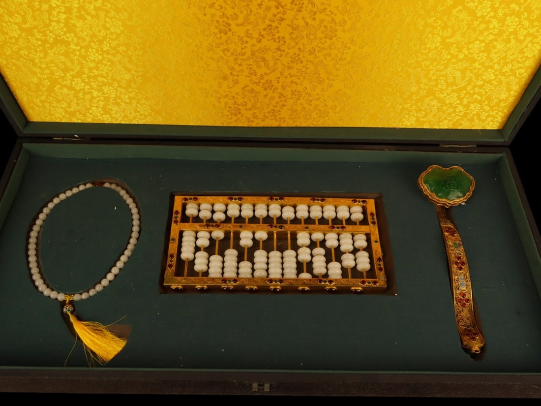 A Set of Fine Gilt Bronze Inlaid White Jade Ornament,Inlaid Gems: A Set of Fine Gilt Bronze Inlaid White Jade Ornament,Inlaid Gems,Qing Dynasty,China,with Qianlong Four-character Mark,Size:(Abacus)12.2inx6.3inx1.2in,(Ruyi)11.8inx3.5inx2.8in,(Bracelets)13in,Weight:(A