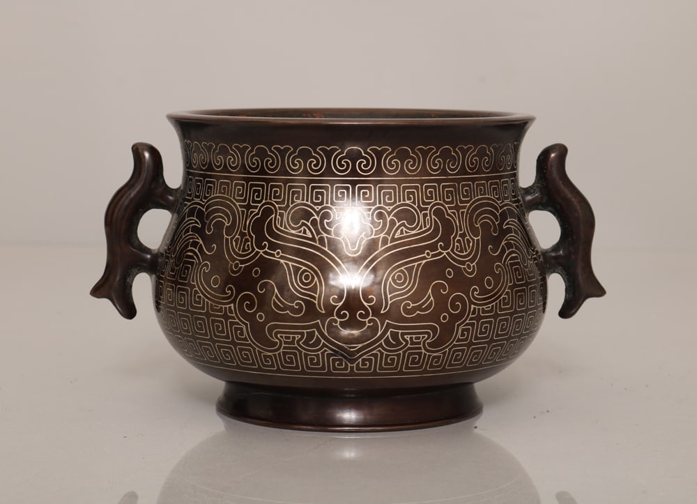 An Exquisite Bronze Inlaid Silver Wire Beast-Face Pattern Double-Ears Censer: An Exquisite Bronze Inlaid Silver Wire Beast-Face Pattern Double-Ears Censer,Ming Dynasty,China,With Mark,Size:3.1inx5.5in,Weight:1387g,铜嵌银丝兽面纹双