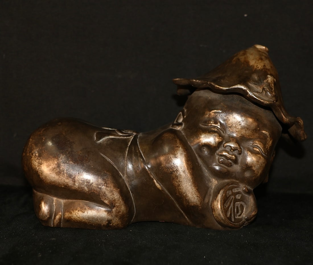 An Exquisite Silver-Gilt Copper Boy Pillow: An Exquisite Silver-Gilt Copper Boy Pillow,Ming Dynasty, China,Size:8.7inx4.7inx5.9in ,Weight:1500g 铜鎏银童子枕,中国明代