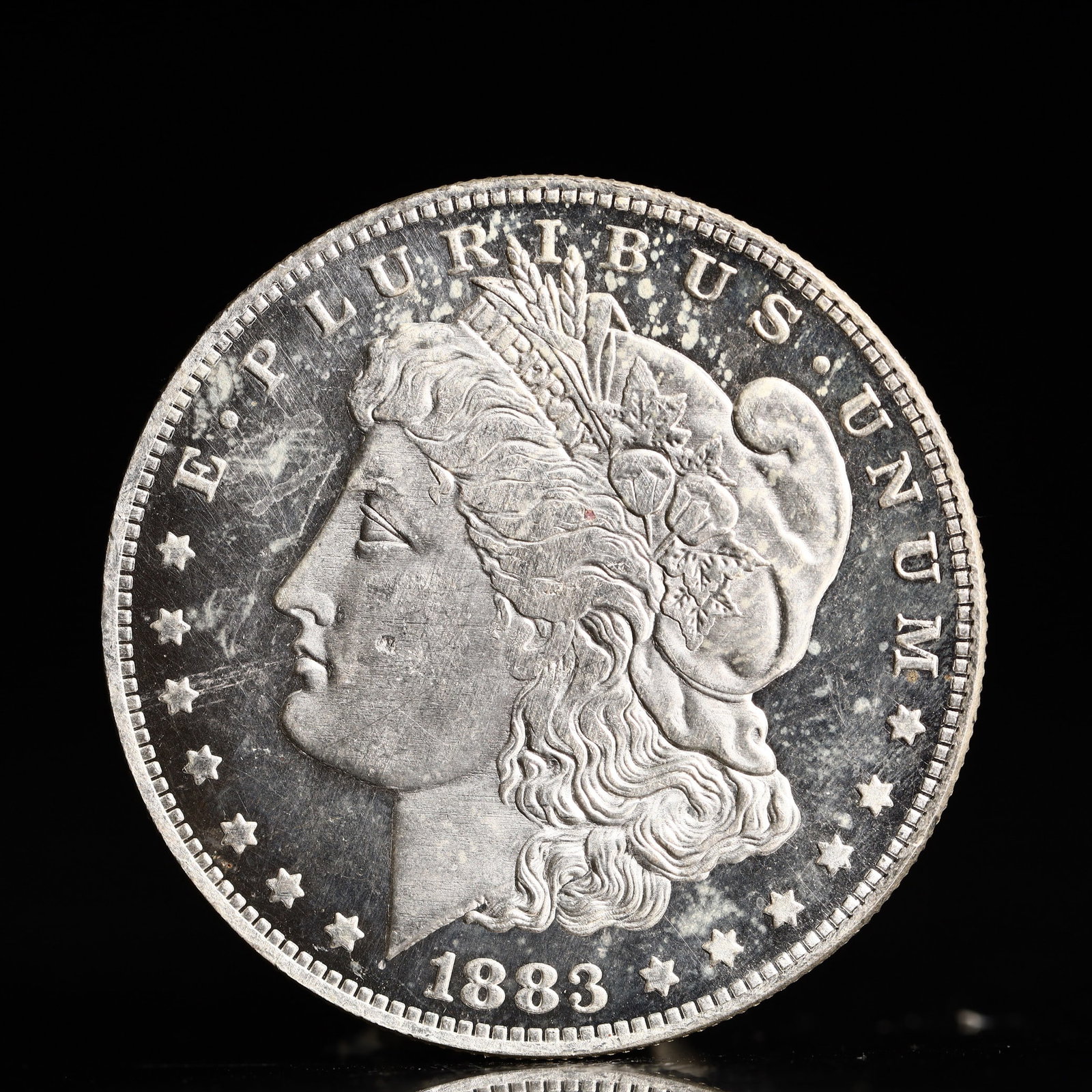 USA Morgan Dollar 1883 Coin: Obv: profile bust with date below and E PLURIBUS UNUM legend and stars around. Rev: eagle with In God we trust above within wreath with UNITED STATES OF AMERICA ONE DOLLAR legend. IN GOD WE TRUST / LI