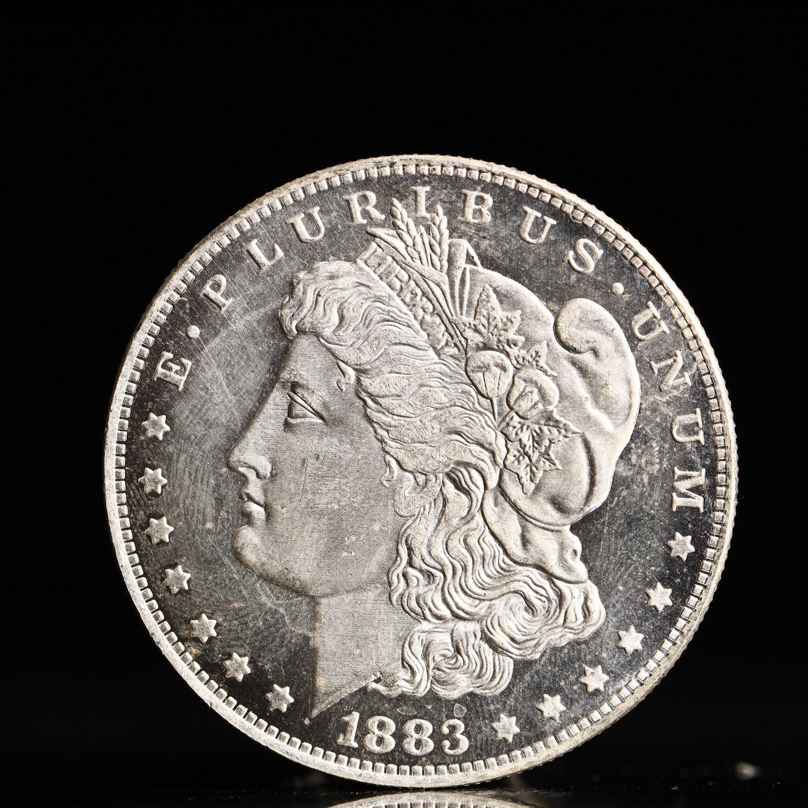 USA Morgan Dollar 1883 Coin: Obv: profile bust with date below and E PLURIBUS UNUM legend and stars around. Rev: eagle with In God we trust above within wreath with UNITED STATES OF AMERICA ONE DOLLAR legend. IN GOD WE TRUST / LI