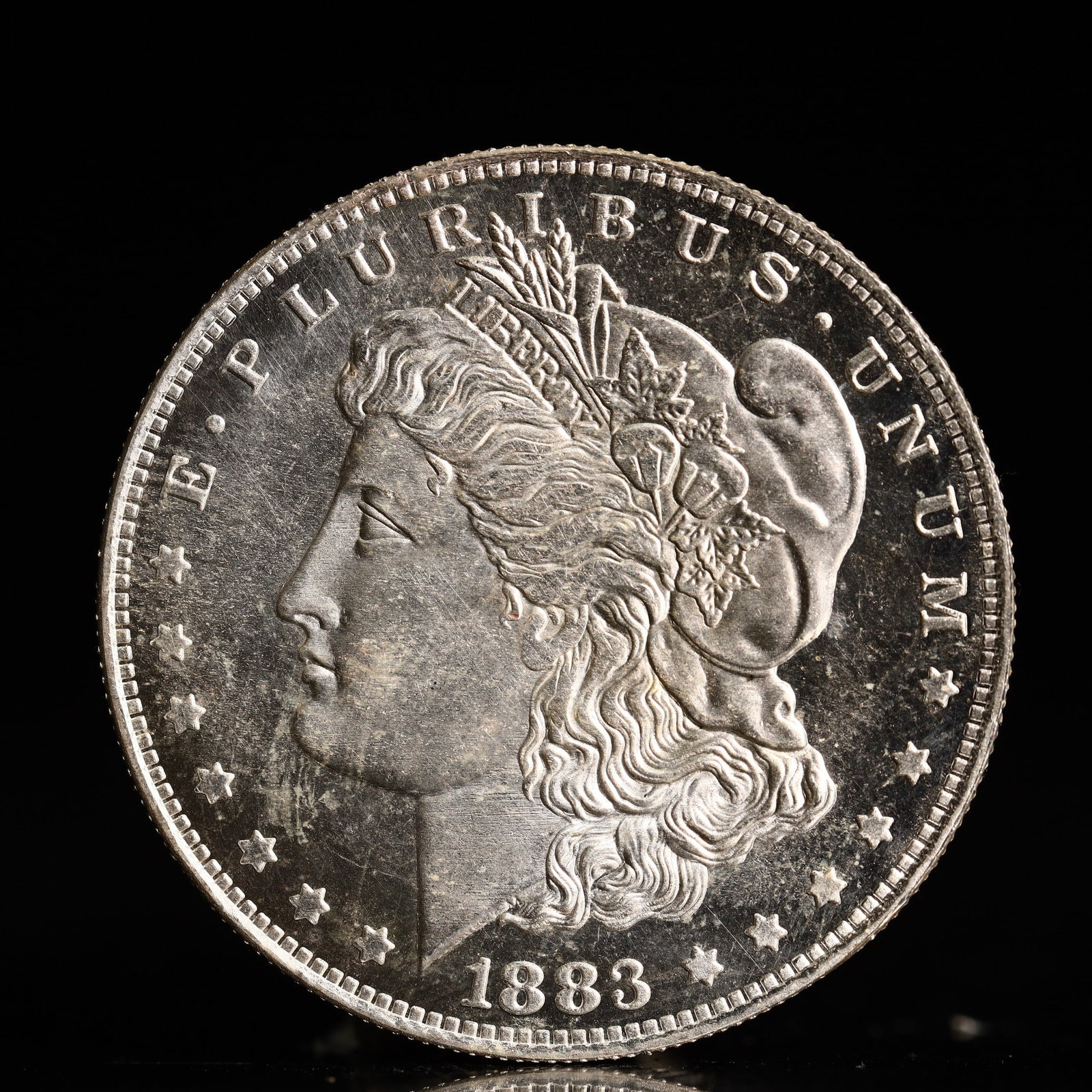 USA Morgan Dollar 1883 Coin: Obv: profile bust with date below and E PLURIBUS UNUM legend and stars around. Rev: eagle with In God we trust above within wreath with UNITED STATES OF AMERICA ONE DOLLAR legend. IN GOD WE TRUST /